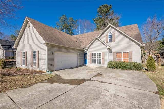 traditional home with driveway and an attached garage