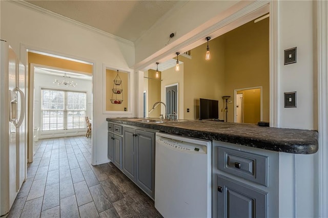 kitchen with white appliances, dark countertops, wood tiled floor, gray cabinets, and crown molding