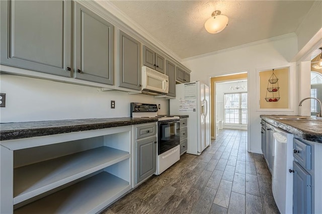 kitchen with white appliances, dark countertops, ornamental molding, open shelves, and a sink