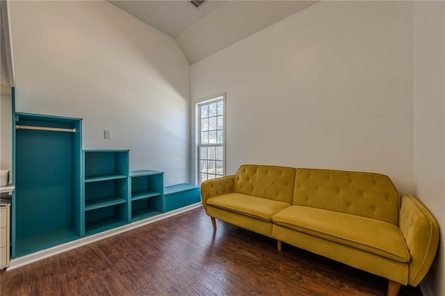 living room featuring vaulted ceiling and wood finished floors