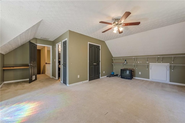 bonus room with lofted ceiling, baseboards, a textured ceiling, and carpet flooring