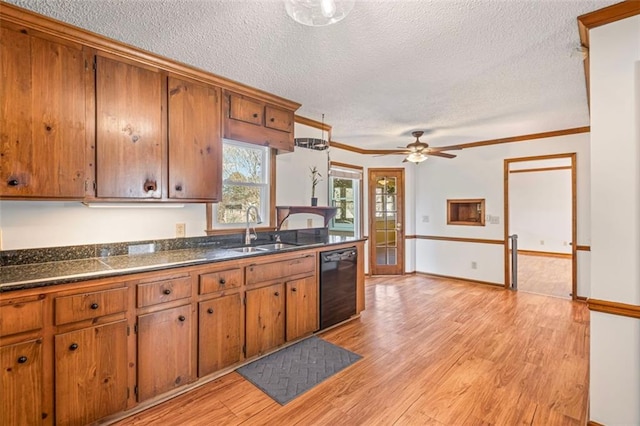 kitchen featuring a sink, dark countertops, brown cabinetry, light wood finished floors, and dishwasher