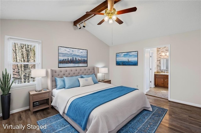 bedroom with ensuite bath, vaulted ceiling with beams, wood finished floors, and baseboards