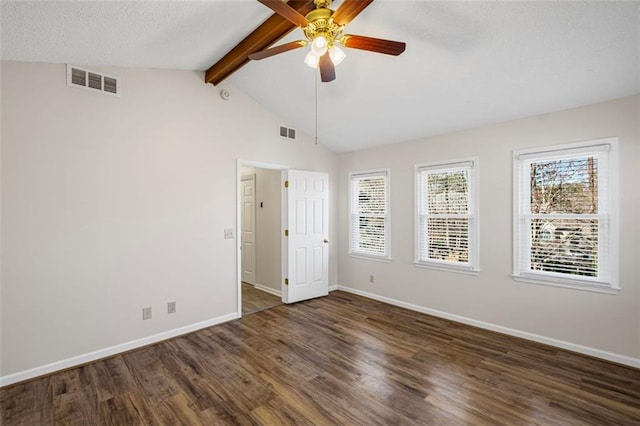 unfurnished room with visible vents, lofted ceiling with beams, baseboards, and wood finished floors