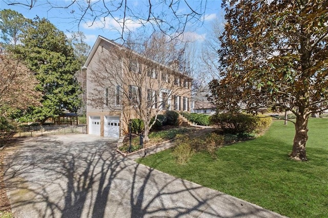 view of front facade featuring aphalt driveway, a garage, a front yard, and fence