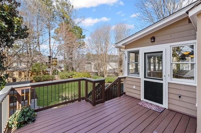 wooden deck featuring a yard