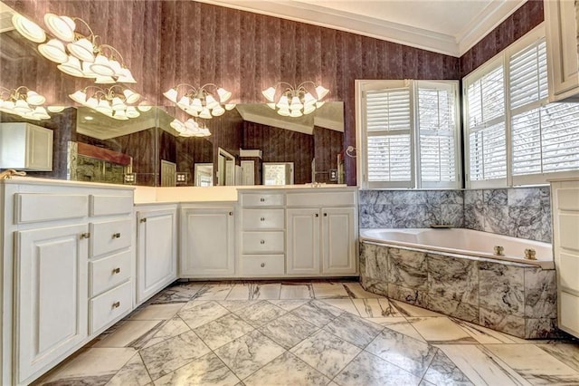 bathroom featuring an inviting chandelier, double sink vanity, crown molding, tile floors, and tiled tub