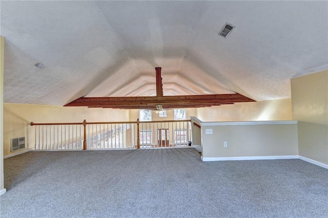 additional living space featuring carpet floors, ceiling fan, a textured ceiling, and lofted ceiling with beams