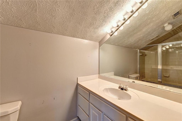 bathroom with toilet, a textured ceiling, vanity, and vaulted ceiling