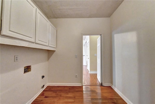 washroom with cabinets, washer hookup, dark hardwood / wood-style floors, and hookup for an electric dryer