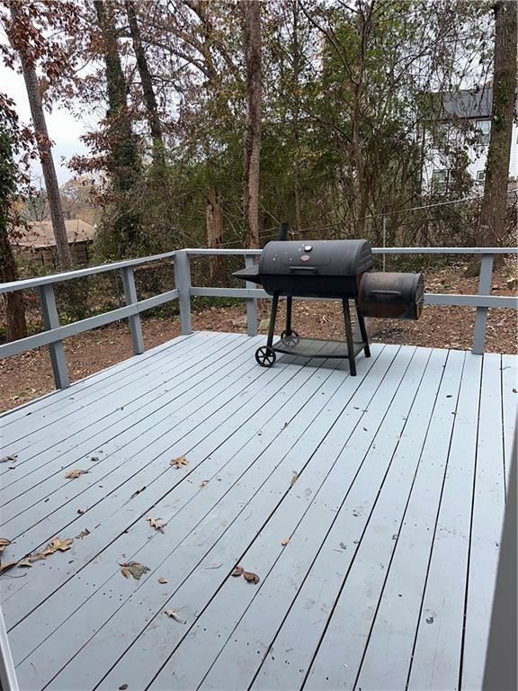 wooden deck featuring a grill