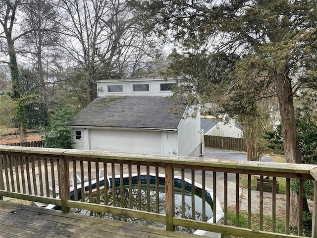 wooden deck with a garage and an outdoor structure