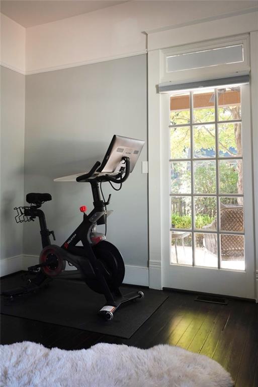 workout room featuring hardwood / wood-style floors and baseboards