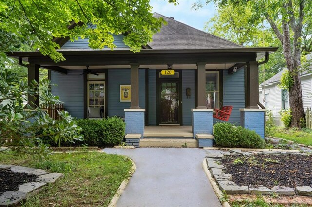 view of front of property featuring covered porch and roof with shingles