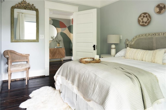 bedroom featuring dark wood-type flooring and baseboards