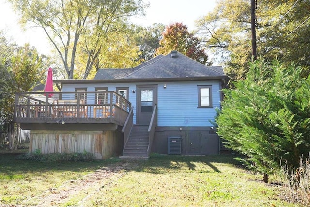 rear view of house featuring roof with shingles, stairway, central AC, a wooden deck, and a yard