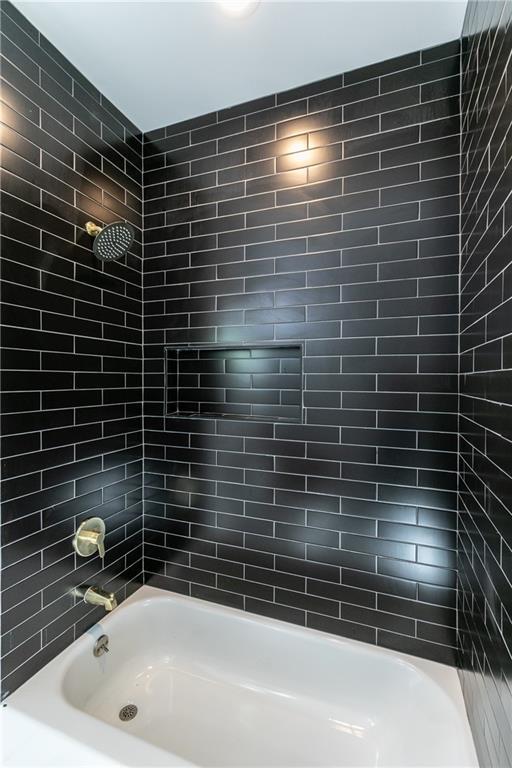 bathroom with shower / washtub combination