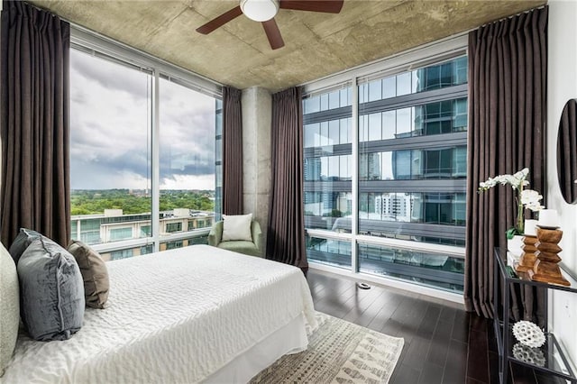 923 Peachtree St NE Unit 1238, Atlanta, GA 30309 - bedroom featuring multiple windows, wood finished floors, expansive windows, and ceiling fan