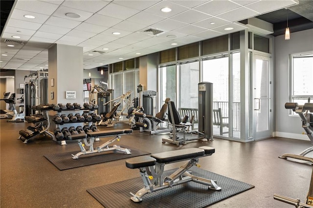 923 Peachtree St NE Unit 1238, Atlanta, GA 30309 - exercise room with a paneled ceiling and baseboards