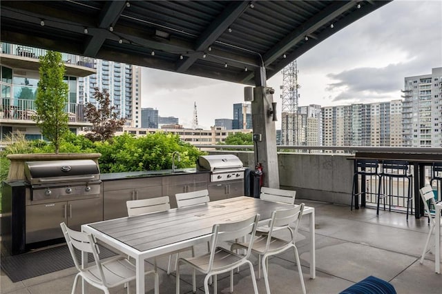 923 Peachtree St NE Unit 1238, Atlanta, GA 30309 - view of patio featuring an outdoor kitchen, a view of city, and outdoor dining area