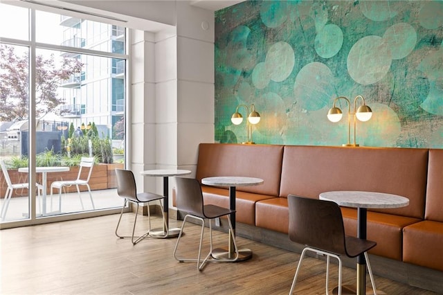 923 Peachtree St NE Unit 1238, Atlanta, GA 30309 - dining area featuring wood finished floors and a wall of windows