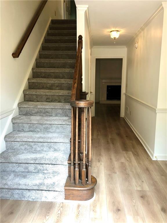 1271 Whitlock Ridge Dr SW, Marietta, GA 30064 - stairway with crown molding and wood finished floors