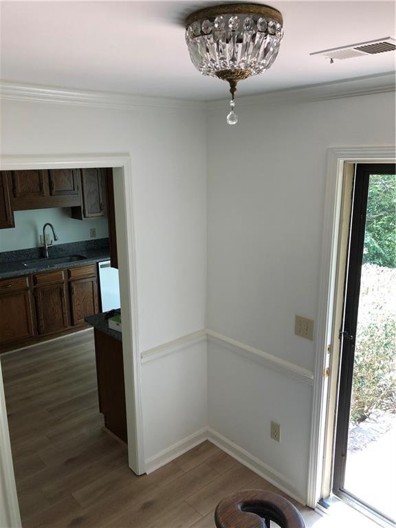 1271 Whitlock Ridge Dr SW, Marietta, GA 30064 - unfurnished dining area with wood finished floors and crown molding
