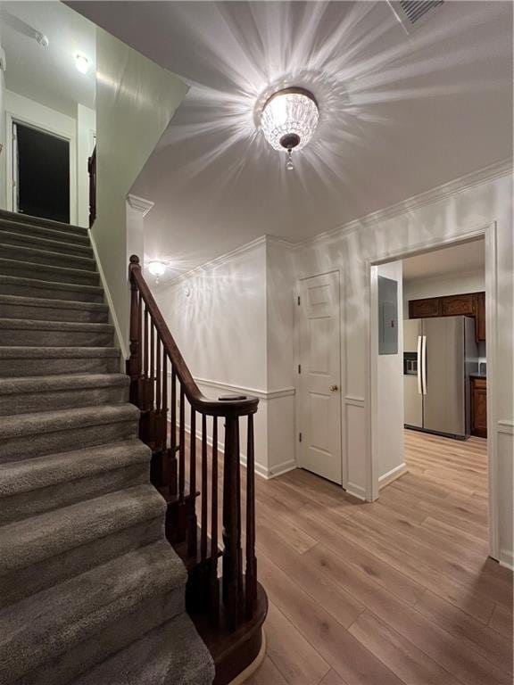 1271 Whitlock Ridge Dr SW, Marietta, GA 30064 - stairs featuring wood finished floors, electric panel, and crown molding