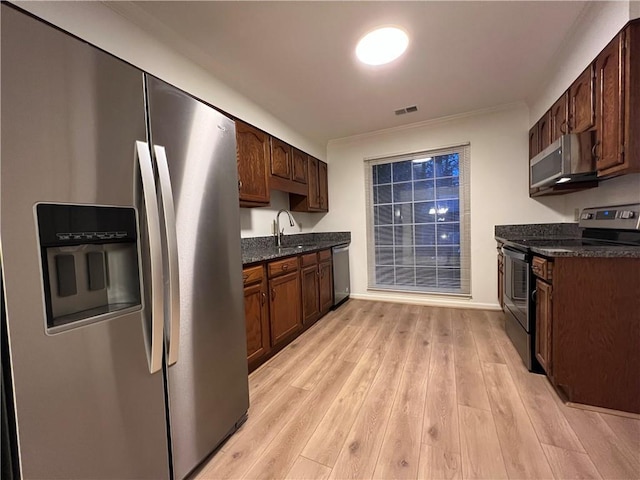 1271 Whitlock Ridge Dr SW, Marietta, GA 30064 - kitchen with appliances with stainless steel finishes, light wood-style floors, dark stone countertops, and dark brown cabinets