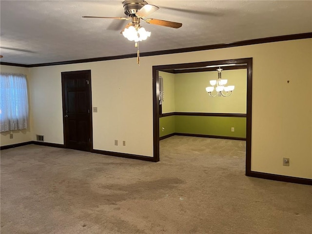 carpeted spare room with crown molding and ceiling fan with notable chandelier