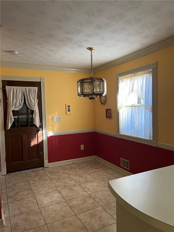 kitchen with kitchen peninsula, white fridge, ceiling fan, light tile patterned flooring, and sink