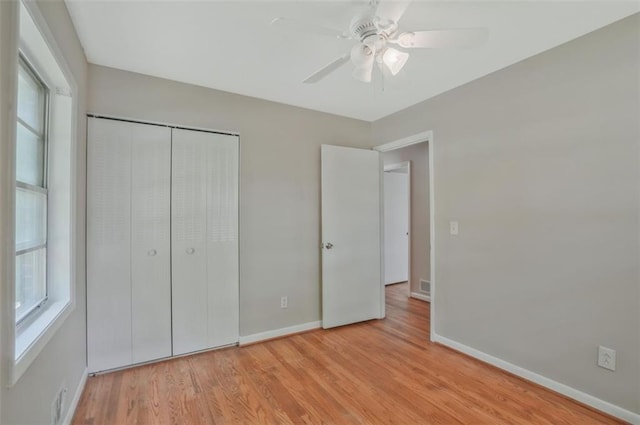 622 Sheffield Rd, Norcross, GA 30071 - unfurnished bedroom featuring baseboards, multiple windows, and light wood-style flooring