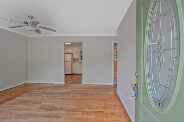 622 Sheffield Rd, Norcross, GA 30071 - entrance foyer with ornamental molding, baseboards, ceiling fan, and light wood finished floors