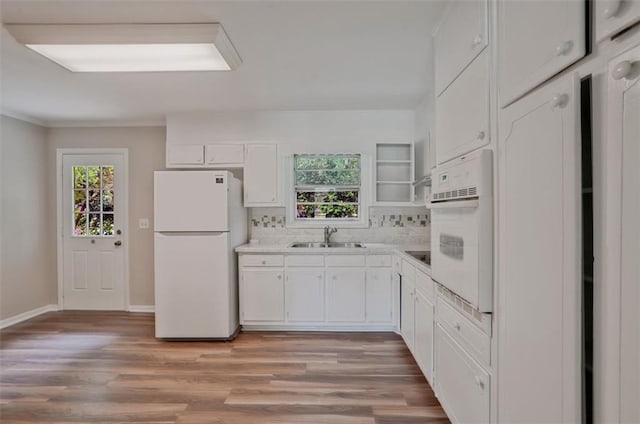 622 Sheffield Rd, Norcross, GA 30071 - kitchen with white appliances, a sink, white cabinetry, tasteful backsplash, and light wood finished floors