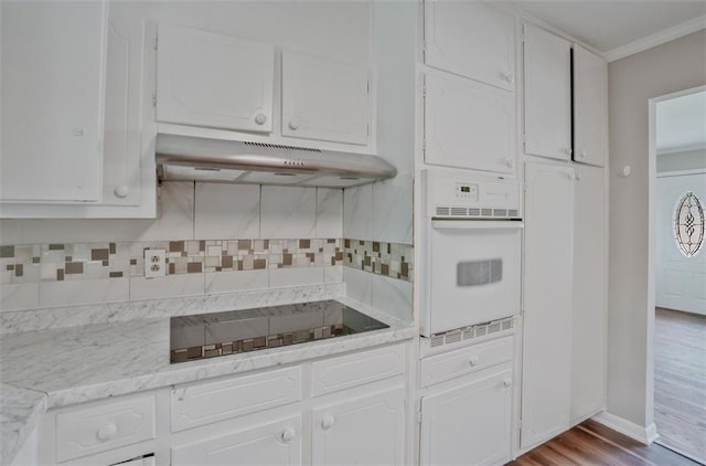 622 Sheffield Rd, Norcross, GA 30071 - kitchen featuring oven, under cabinet range hood, black electric stovetop, white cabinets, and light countertops