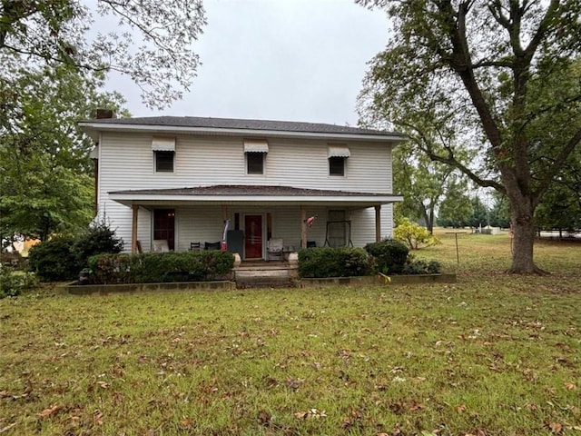 front of property with covered porch and a front lawn