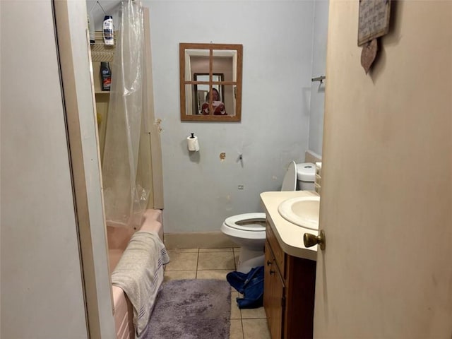 full bathroom with tile patterned floors, shower / bath combo with shower curtain, vanity, and toilet