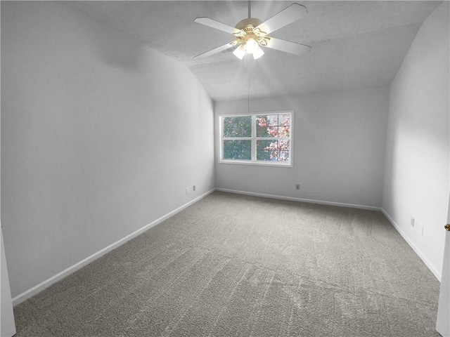 unfurnished room with carpet flooring, ceiling fan, and vaulted ceiling