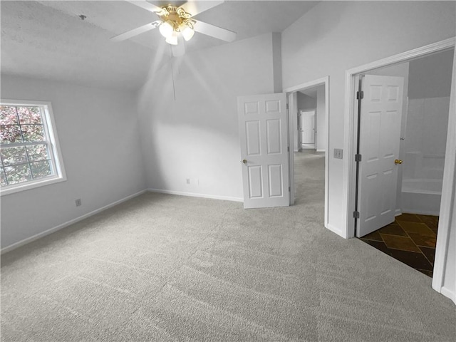 unfurnished bedroom with ceiling fan, carpet, and lofted ceiling