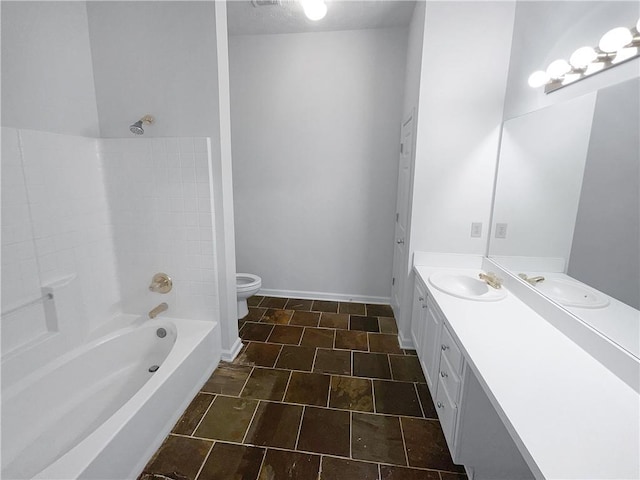 4279 Orchard Grv, Stone Mountain, GA 30083 - bathroom with vanity, toilet, bathtub / shower combination, stone finish floors, and baseboards