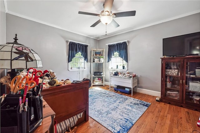 bedroom featuring ceiling fan, hardwood / wood-style floors, and ornamental molding