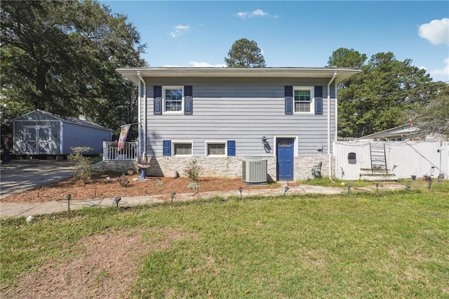 exterior space featuring a yard, central AC unit, and a storage shed