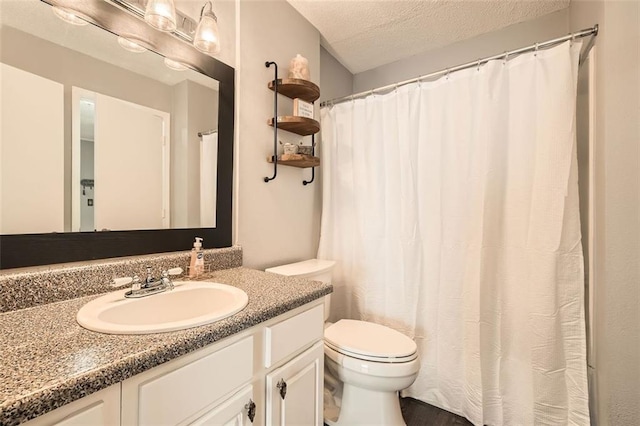 full bathroom with toilet, a textured ceiling, and vanity