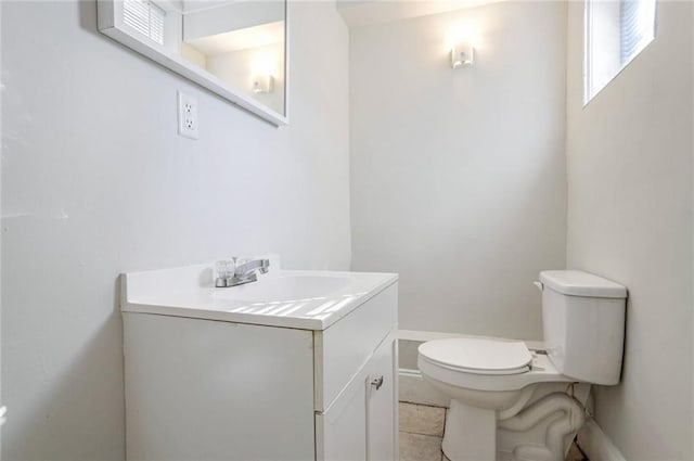 bathroom featuring vanity, toilet, and tile patterned flooring