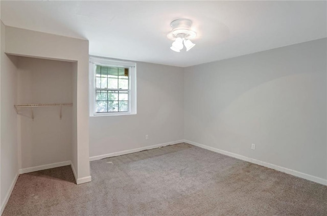 unfurnished bedroom featuring light colored carpet, a closet, and ceiling fan