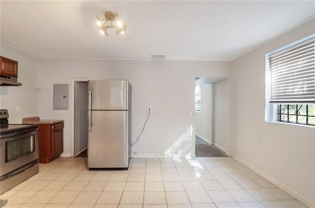 kitchen featuring exhaust hood, light tile patterned flooring, electric panel, and stainless steel appliances