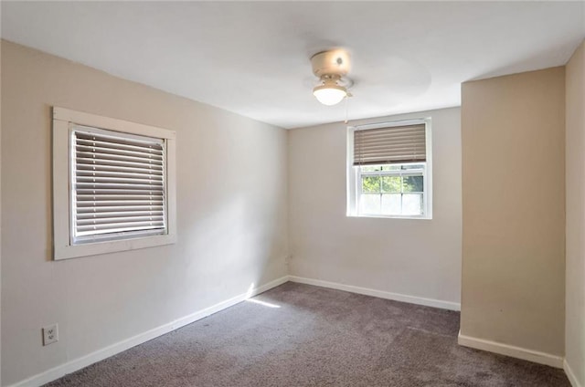 carpeted spare room featuring ceiling fan