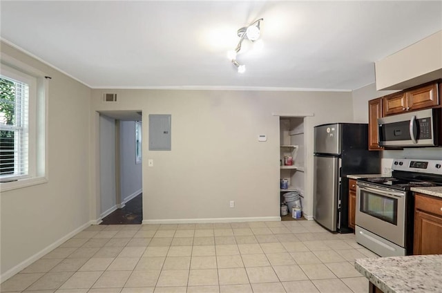 kitchen featuring crown molding, electric panel, stainless steel appliances, and light tile patterned floors