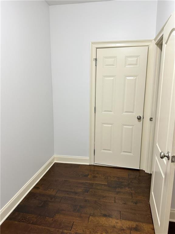 unfurnished room featuring dark hardwood / wood-style flooring