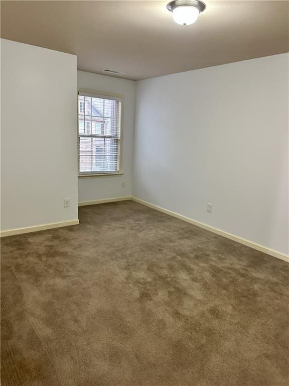 empty room with dark carpet